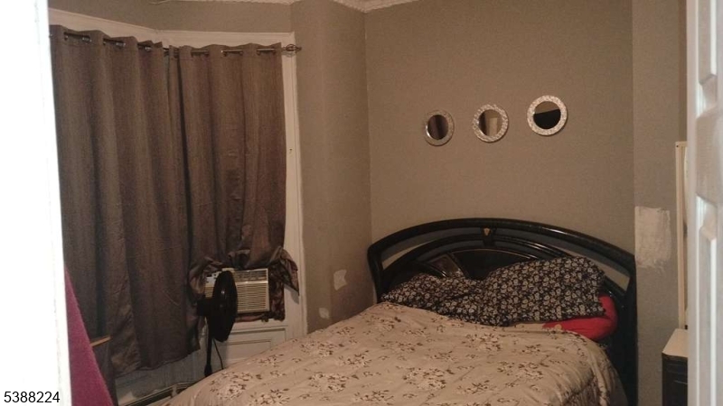 249 Summer Avenue Newark, NJ 07104 - Photo 4 of 16 a bedroom with a bed and a wall painting