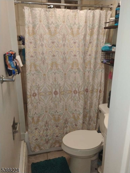 249 Summer Avenue Newark, NJ 07104 - Photo 8 of 16 a bathroom with a toilet and a shower curtain
