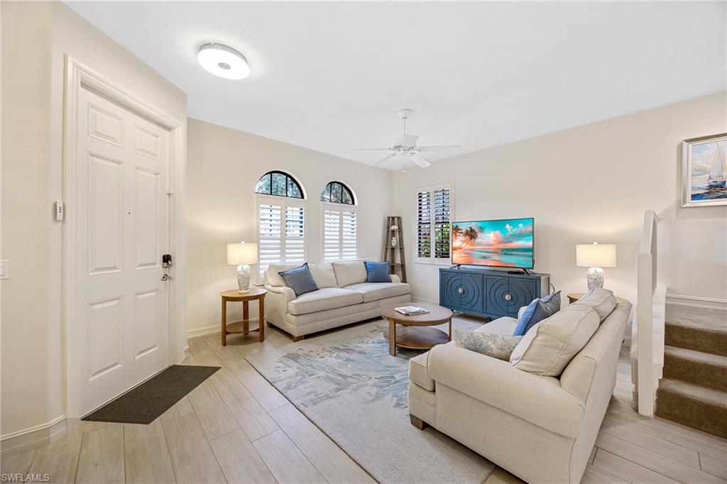 9076 Rialto Street, Unit 62 Naples, FL 34113 - Photo 11 of 50 a living room with furniture and a flat screen tv