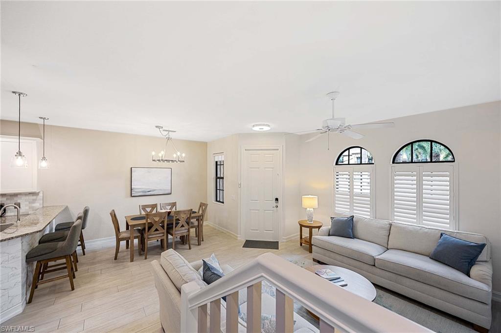 9076 Rialto Street, Unit 62 Naples, FL 34113 - Photo 12 of 50 a living room with furniture and a large window