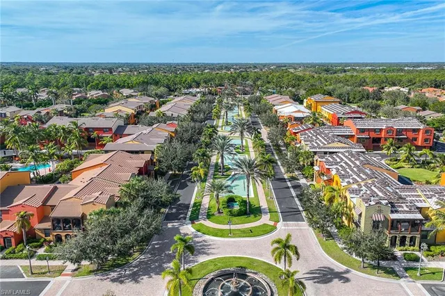 an aerial view of residential houses with outdoor space and ocean view