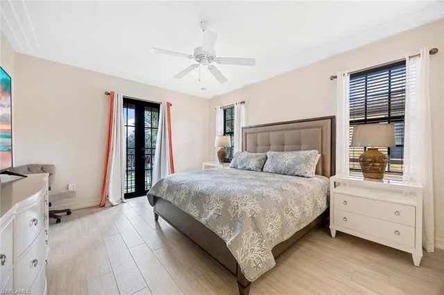 a bedroom with a large bed and a chandelier