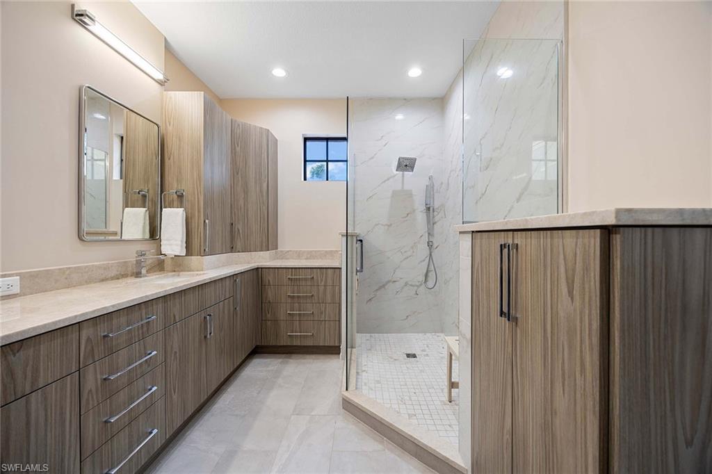 9076 Rialto Street, Unit 62 Naples, FL 34113 - Photo 25 of 50 a bathroom with a double vanity sink mirror and shower