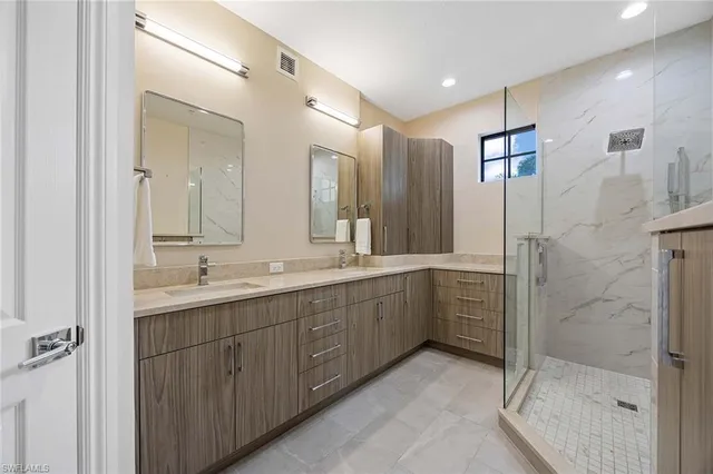 a bathroom with a double vanity sink mirror and double