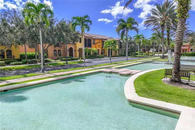 a view of a house with swimming pool and a yard