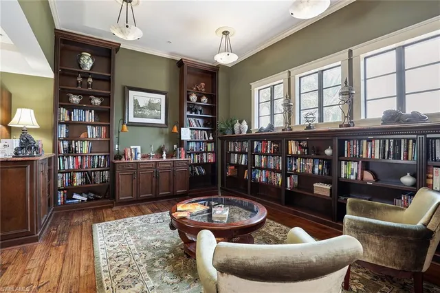 a living room with furniture a rug and a bookshelf
