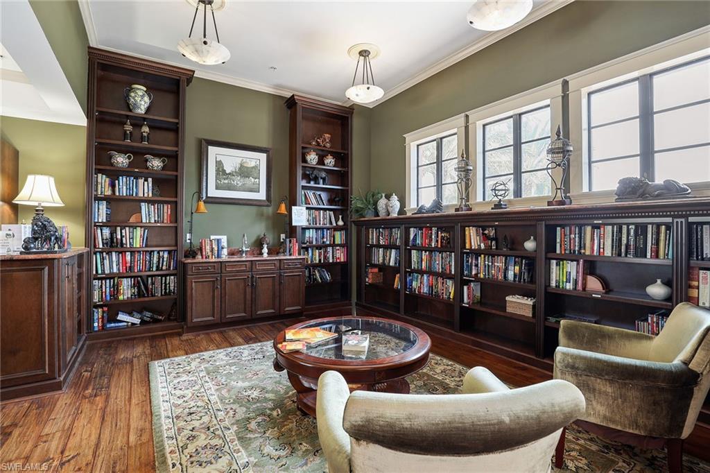 9076 Rialto Street, Unit 62 Naples, FL 34113 - Photo 46 of 50 a living room with furniture a rug and a bookshelf