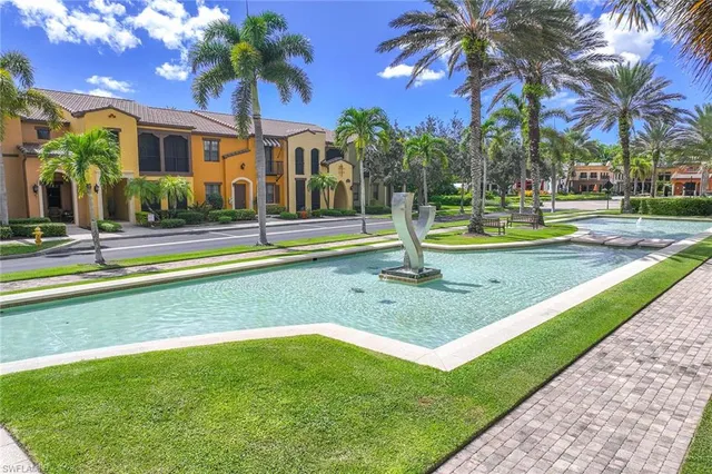 a view of a house with swimming pool and a tree