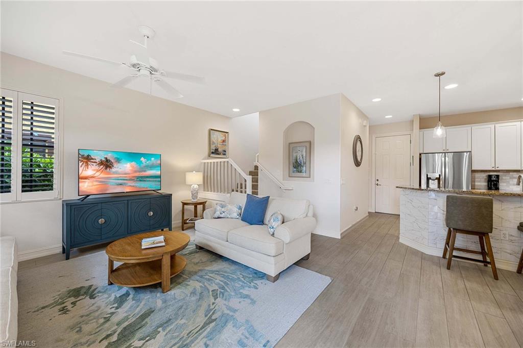 9076 Rialto Street, Unit 62 Naples, FL 34113 - Photo 9 of 50 a living room with furniture and a flat screen tv