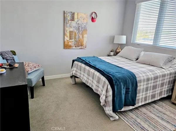 a bedroom with a bed and a table in it