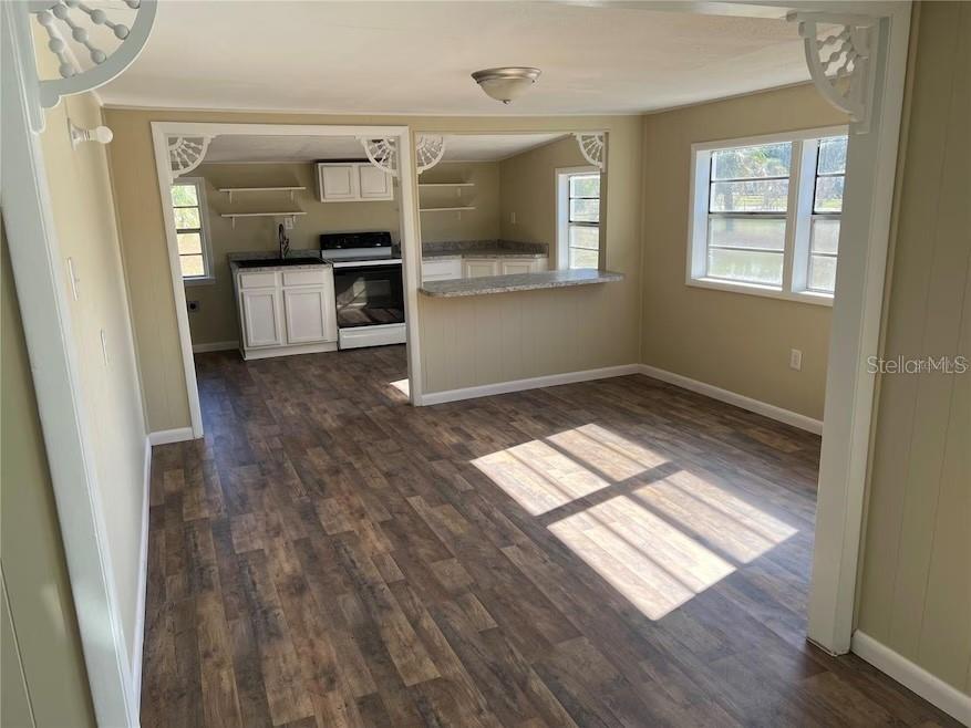 9601 Southeast 155th Street Summerfield, FL 34491 - Photo 3 of 7 wooden floor in an empty room with a window