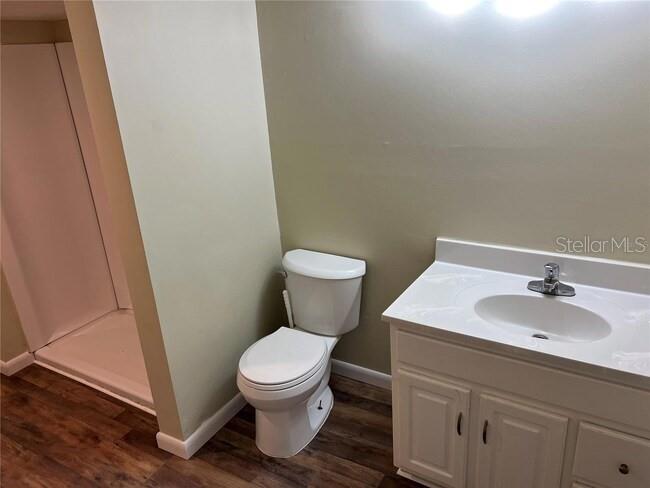 9601 Southeast 155th Street Summerfield, FL 34491 - Photo 4 of 7 a white toilet sitting next to a bathroom sink