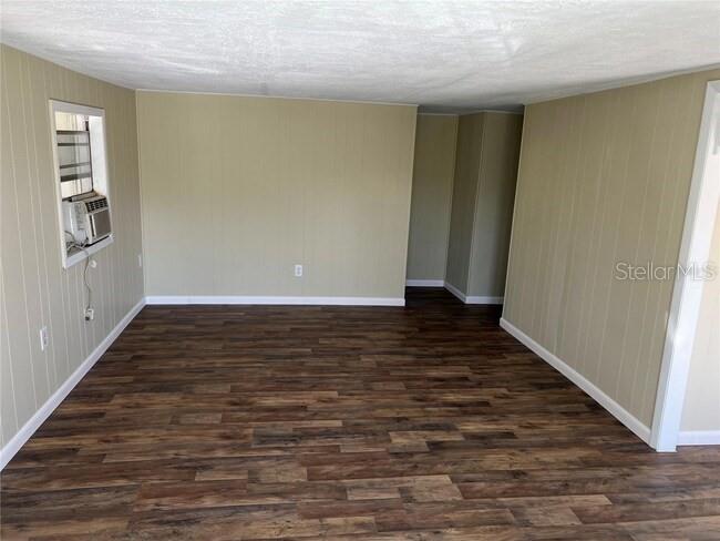9601 Southeast 155th Street Summerfield, FL 34491 - Photo 5 of 7 a view of an empty room with wooden floor