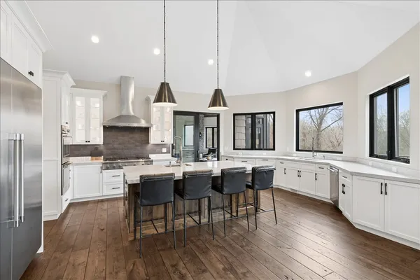 a large kitchen with lots of counter space and stainless steel appliances