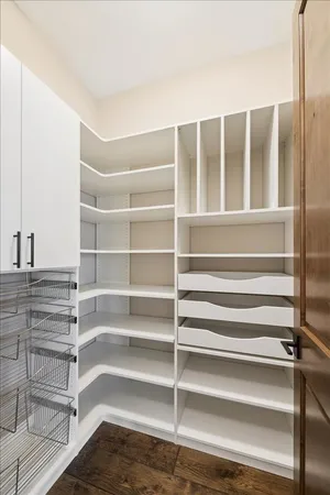 a view of walk in closet with empty racks