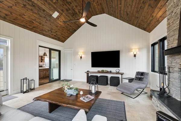 a living room with furniture a flat screen tv and a table