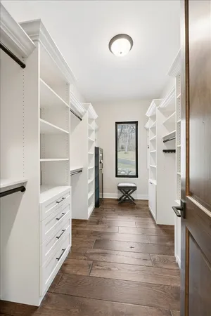 a view of walk in closet with empty racks