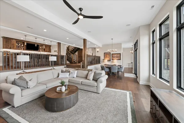 a spacious kitchen with stainless steel appliances granite countertop a sink and a wooden floor