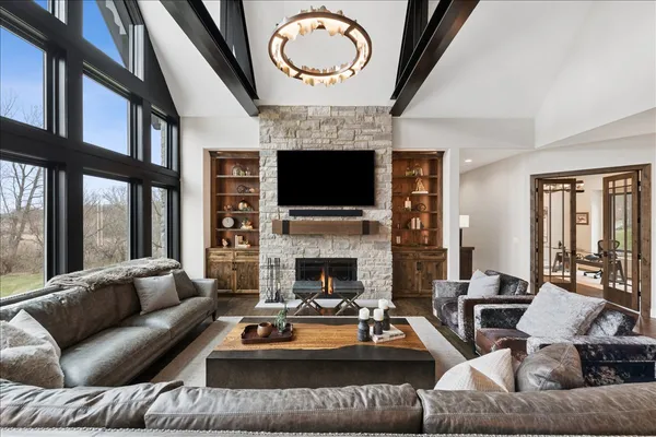 a living room with furniture a fireplace and a flat screen tv