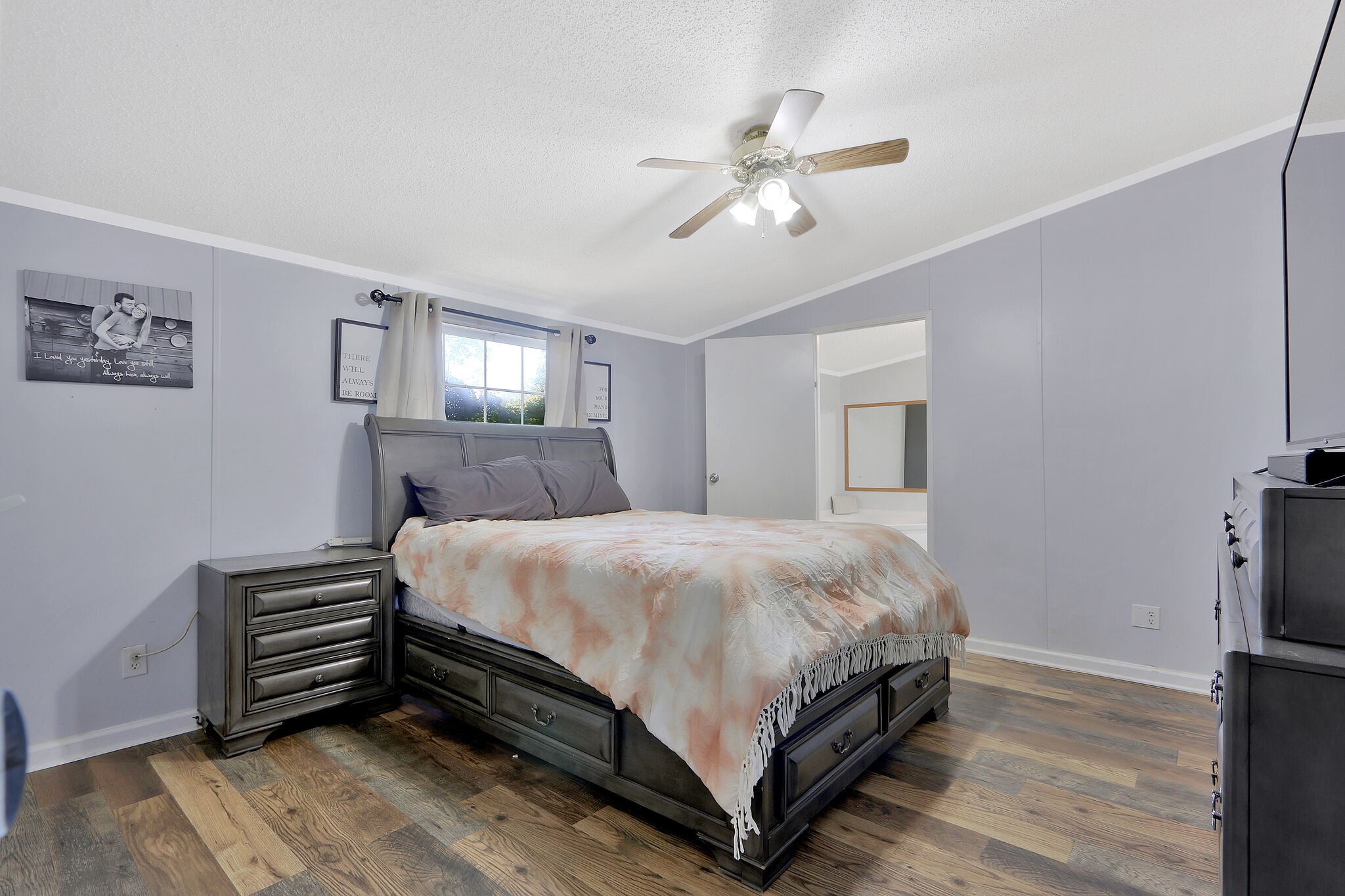 2218 Lee Road Spring Hill, TN 37174 - Photo 10 of 19 a bedroom with a bed and a chandelier