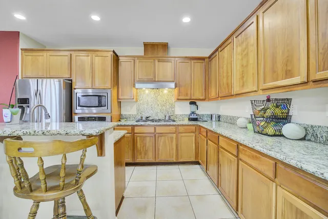 a view of a livingroom with furniture a flat screen tv and floor to ceiling window
