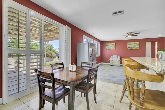 a bathroom with a granite countertop sink toilet and mirror