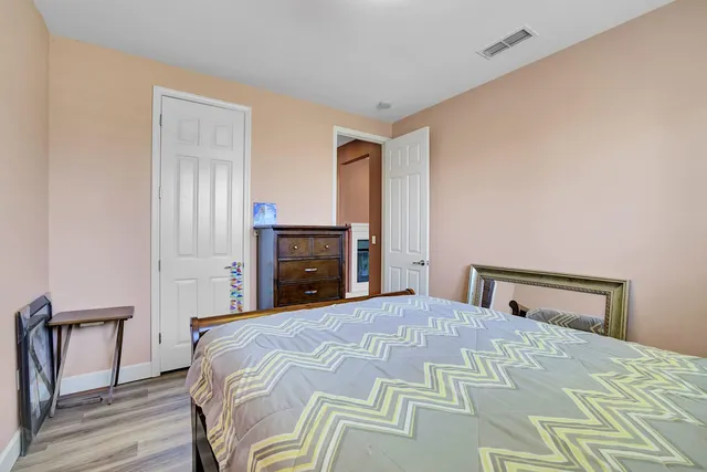 a view of a livingroom with wooden floor and furniture