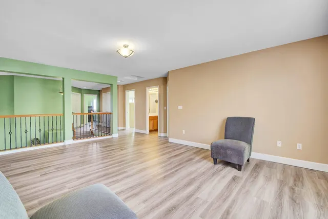 a bathroom with a granite countertop sink a toilet a mirror and bathtub