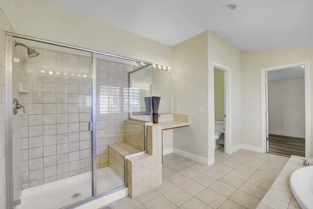 a bedroom with a bed and a mirror