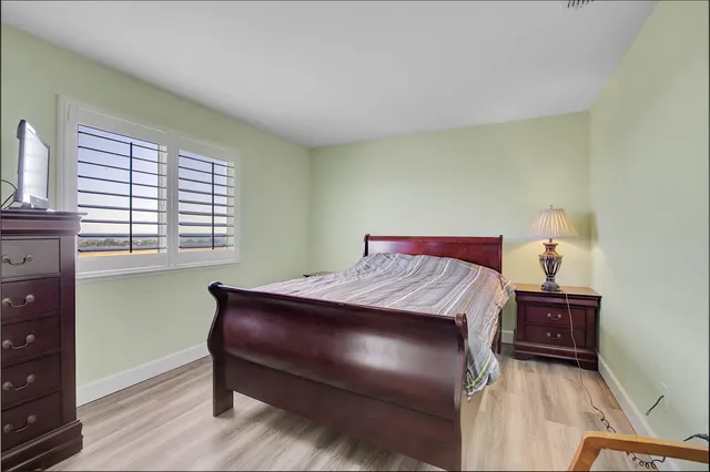 a view of a house with brick walls and a yard with plants