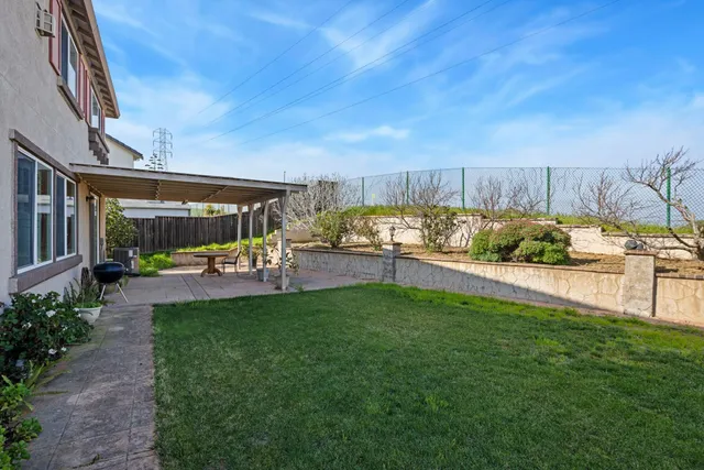 an aerial view of residential houses with outdoor space and ocean view