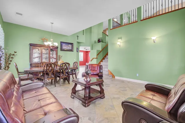 a kitchen with stainless steel appliances kitchen island granite countertop a refrigerator and cabinets