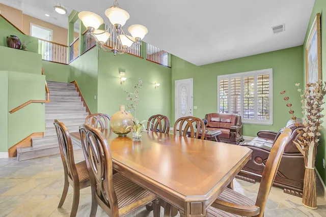 a view of a dining room with furniture and chandelier