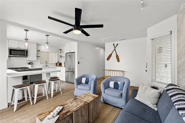 a living room with furniture and kitchen view