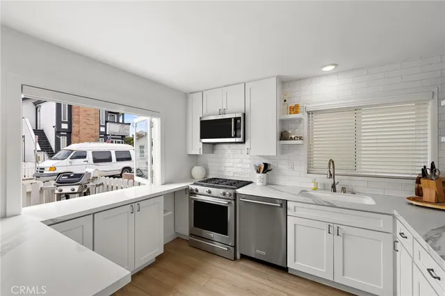 a kitchen with a sink stove and microwave