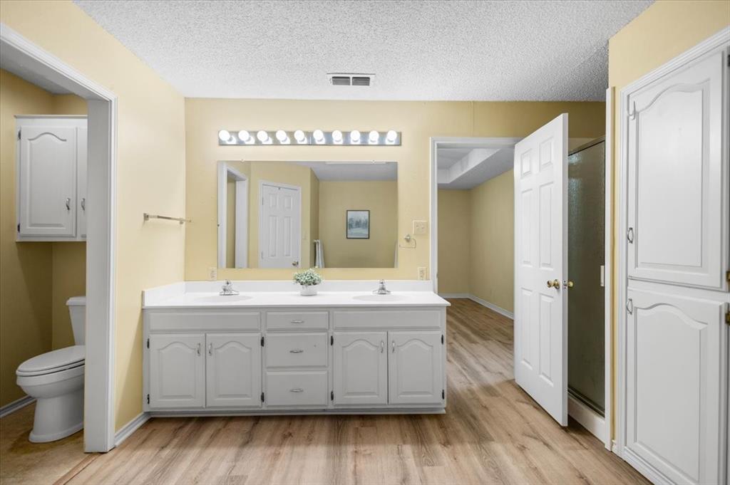 2824 Crestview Avenue Tyler, TX 75701 - Photo 29 of 39 a spacious bathroom with a double vanity sink and a mirror