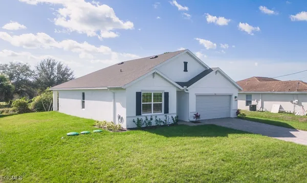 a front view of house with yard and green space