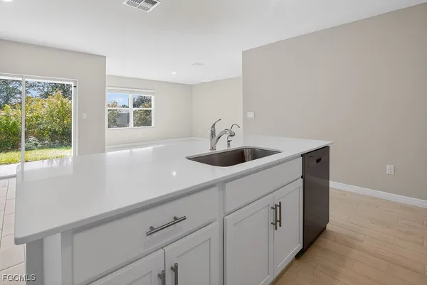a kitchen with a sink and window