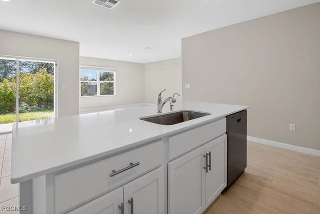a kitchen with a sink and window