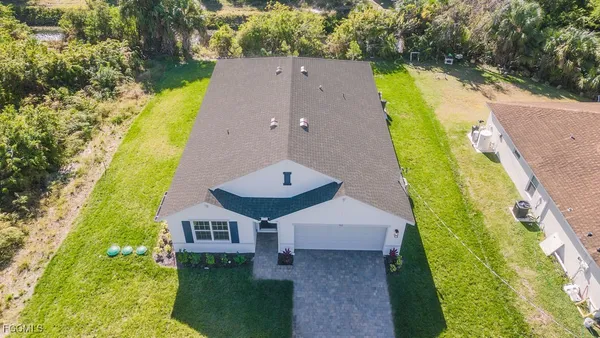 an aerial view of a house with a swimming pool