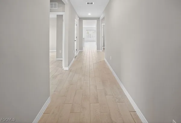 a view of a hallway with wooden floor