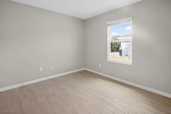 a view of an empty room and wooden floor