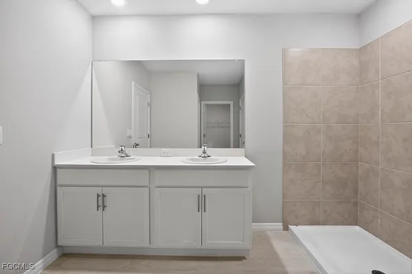 a white toilet sitting next to a white sink