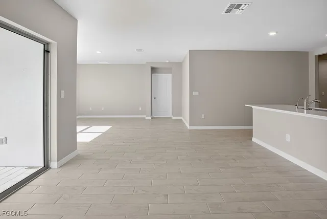 a view of kitchen with stainless steel appliances refrigerator stove microwave and cabinets