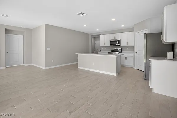 a view of kitchen with cabinets and wooden floor