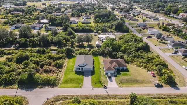 an aerial view of residential houses with outdoor space and swimming pool