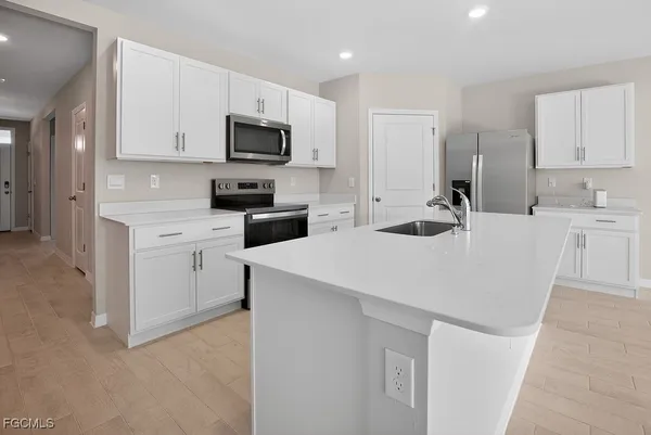 a kitchen with a sink a stove and cabinets