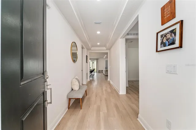 a view of a hallway with wooden floor and staircase