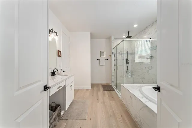 a spacious bathroom with a bathtub and a shower
