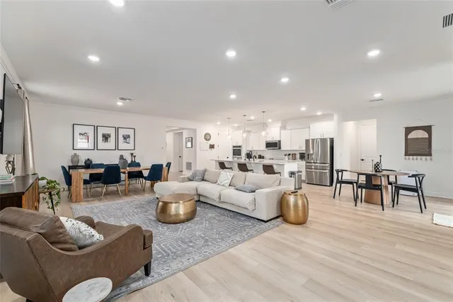 a living room with furniture and view of kitchen